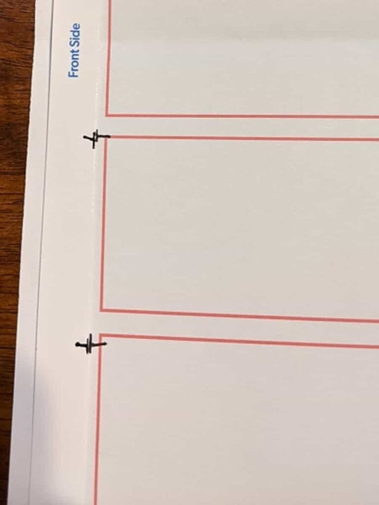 comparing test printout with a marked template for publisher business cards